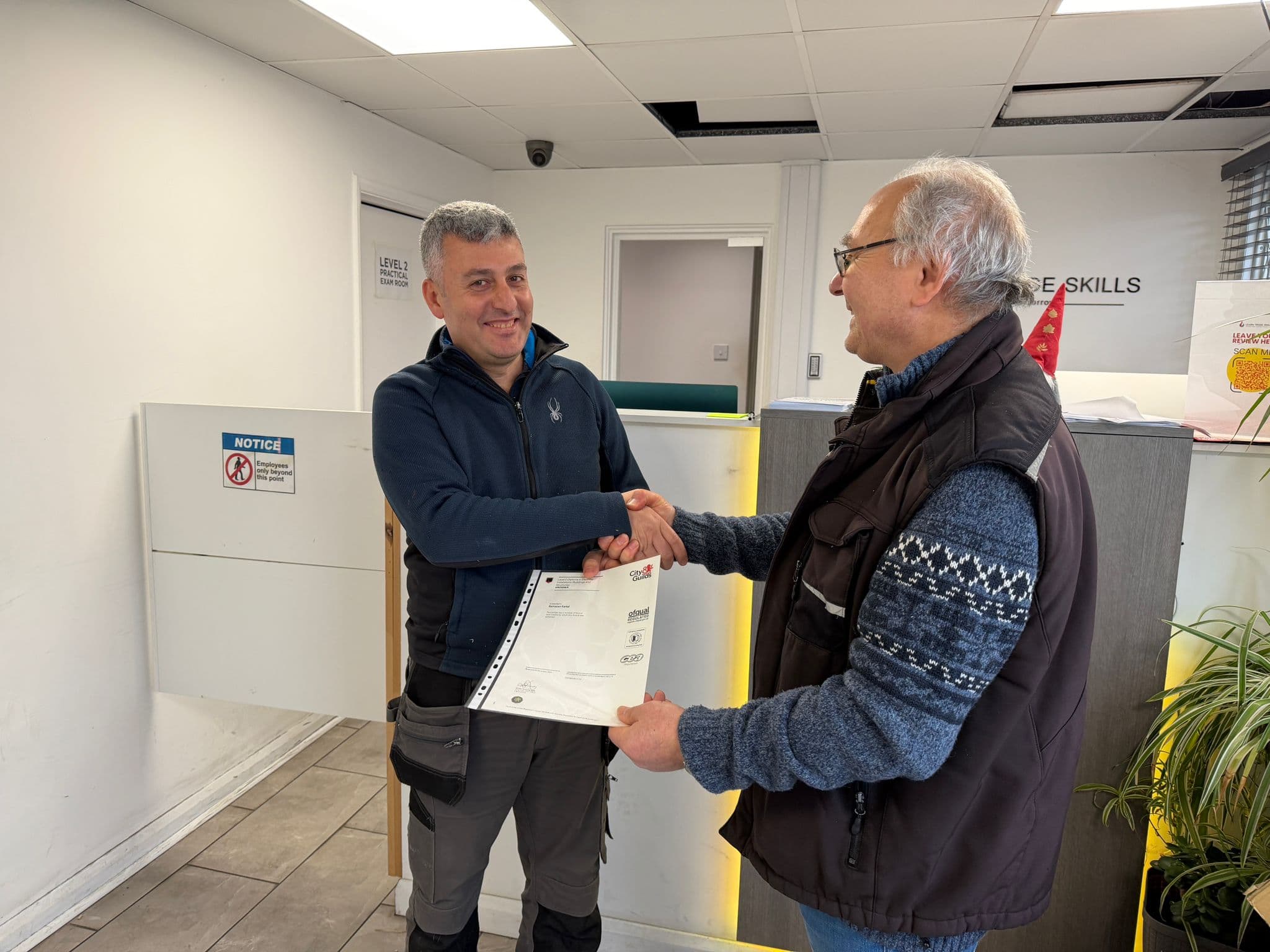 Graduate receiving City & Guilds certificate