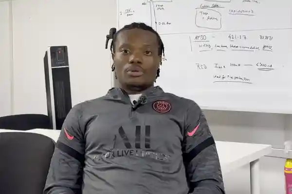 Ike, a Learn Trade Skills student, shares his experience after completing Level 2 of the Gold Card electrician course, seated in a classroom with a whiteboard behind him.