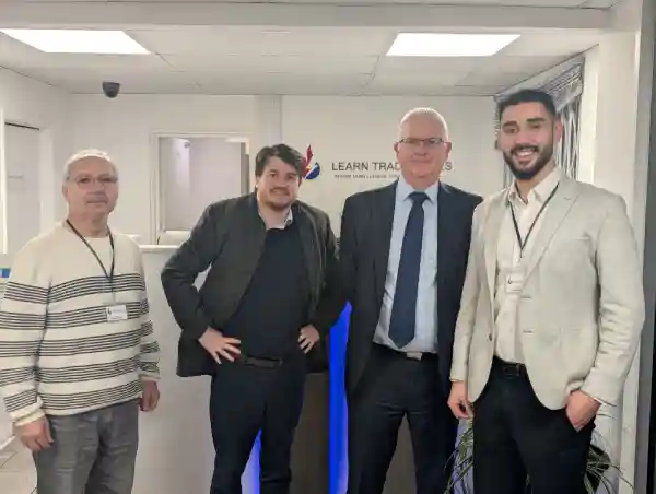 Sezai Aramaz, Director of Learn Trade Skills; Duncan Haslam, Economic Development Manager at Broxbourne Council; Jeff Stack, Chief Executive of Broxbourne Council; and Tolga Aramaz, CEO of Learn Trade Skills, standing together at the Learn Trade Skills reception, highlighting a strategic partnership to advance vocational education and local economic growth.