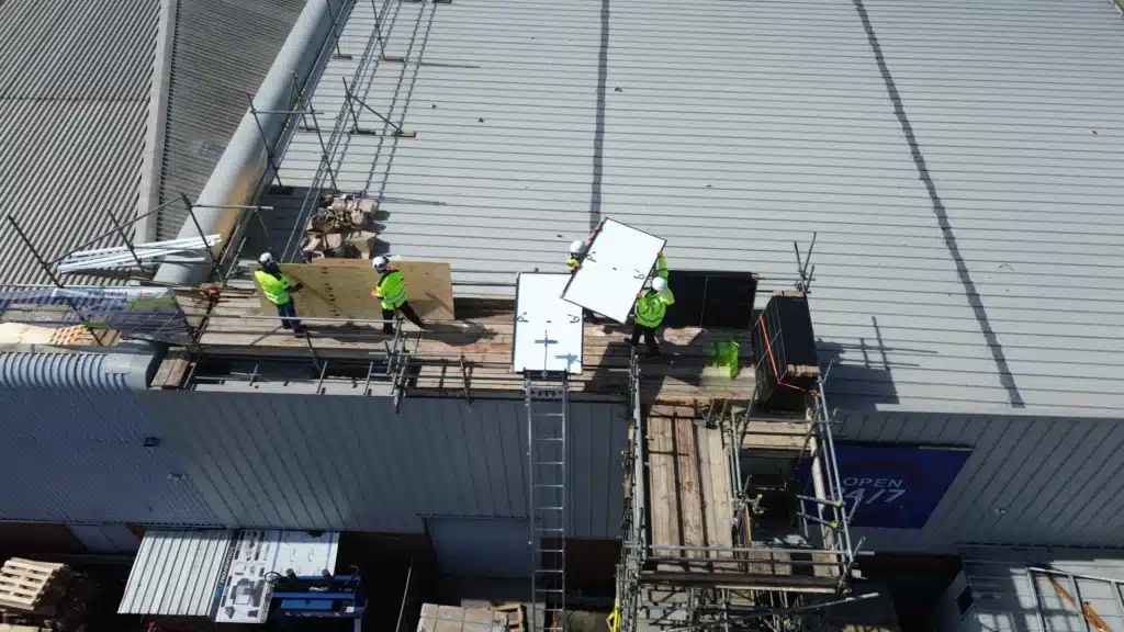 Learn Trade Skills trainees working safely at height during solar panel installation, demonstrating CPD training in manual handling and working at height as part of electrical trade education in Hertfordshire.