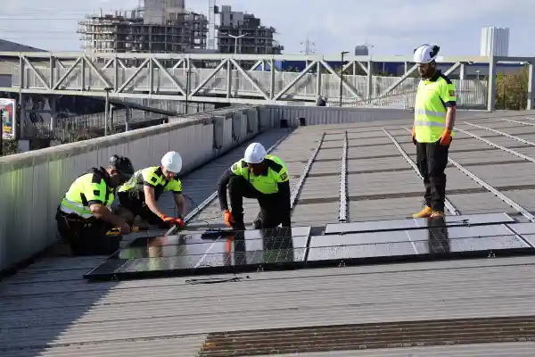 Learn Trade Skills trainees installing rooftop solar panels under instructor supervision, showcasing hands-on electrical training for the UK’s clean energy sector.