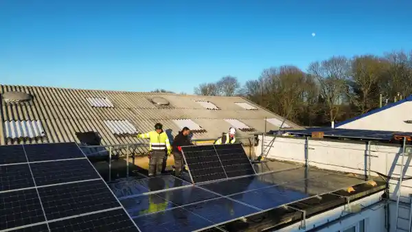 Learn Trade Skills trainees installing solar panels on the Cheshunt training centre roof as part of City & Guilds solar PV course